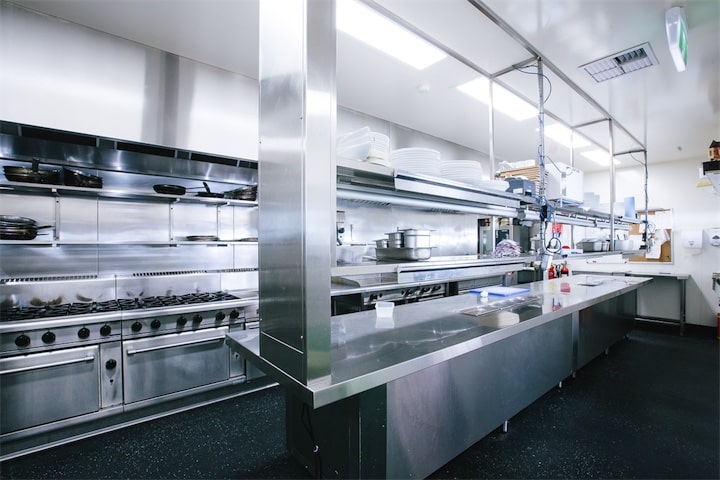 Stainless steel commercial kitchen with gas stoves